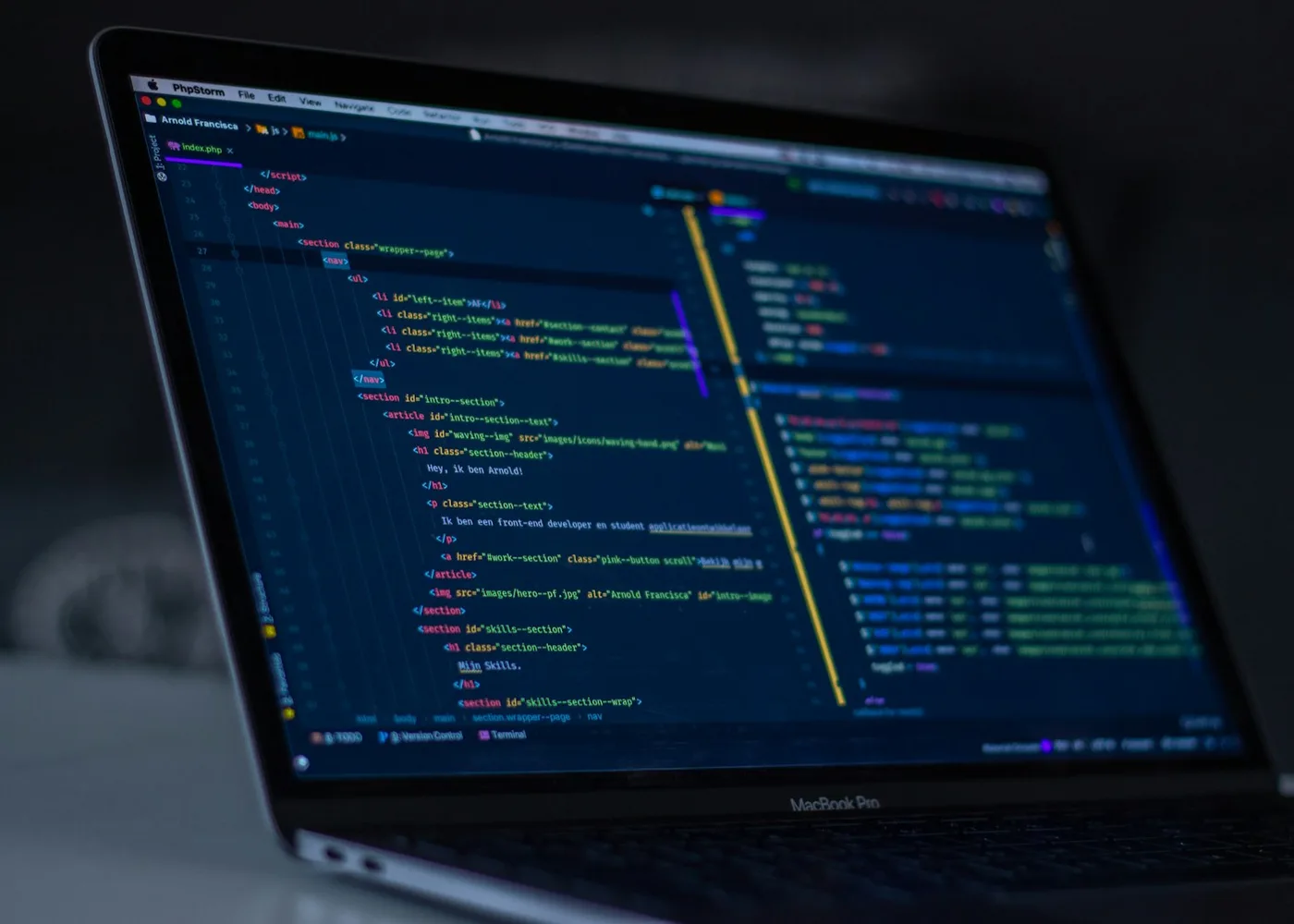 Code editor open on a laptop in a dark room